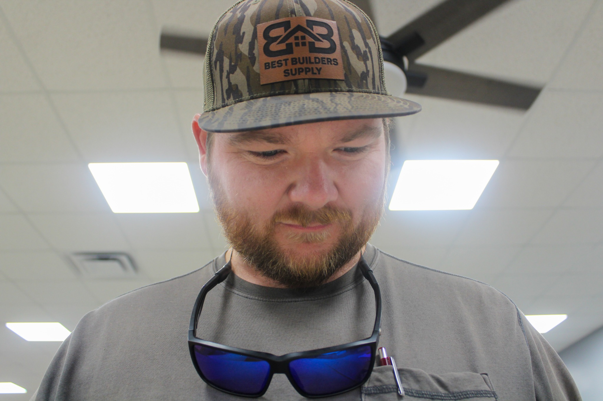 Best Builders Supply team member wearing a company logo cap