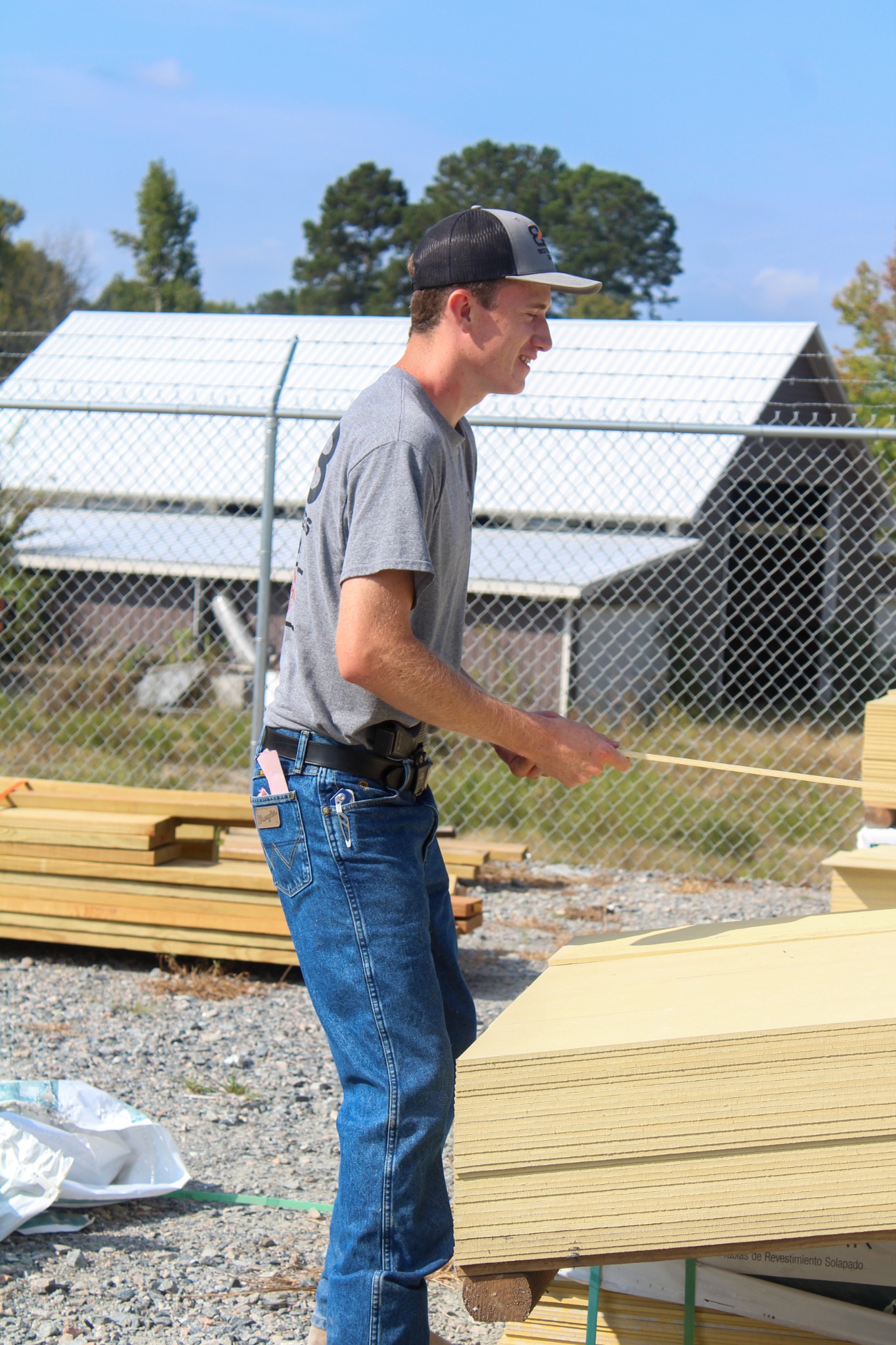 Braydon organizing lumber in the Best Builders Supply yard